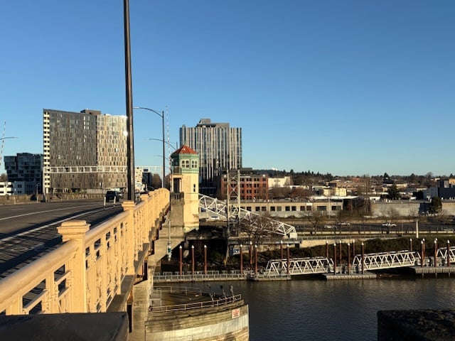 Two tall black glass buildings on either side of the far end of the bridge.